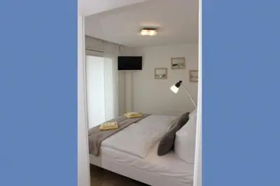 Ein Bett oder Betten in einem Zimmer der Unterkunft Käptn Brass Appartement 13