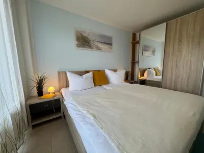 Ein Bett oder Betten in einem Zimmer der Unterkunft Käptn Brass Appartement 14 Meeresbrise