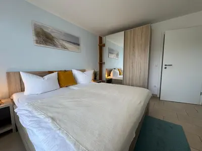 Ein Bett oder Betten in einem Zimmer der Unterkunft Käptn Brass Appartement 14 Meeresbrise