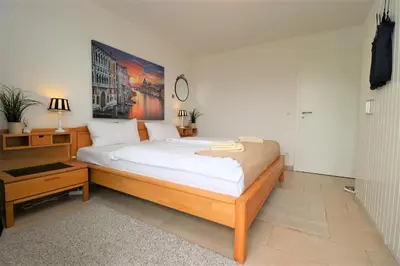 Ein Bett oder Betten in einem Zimmer der Unterkunft Käptn Brass Appartement 15 Deichblick