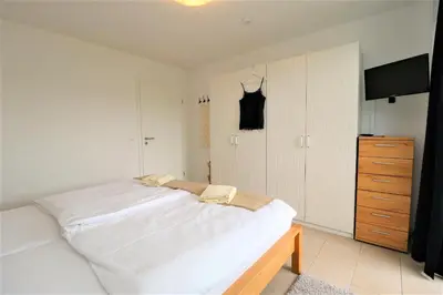 Ein Bett oder Betten in einem Zimmer der Unterkunft Käptn Brass Appartement 15 Deichblick