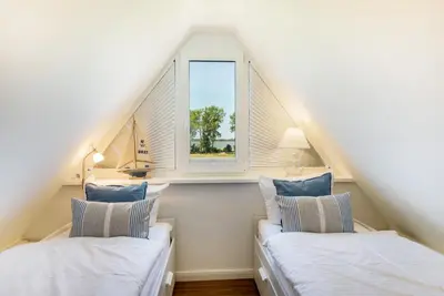 Ein Bett oder Betten in einem Zimmer der Unterkunft Haus TraumAnker