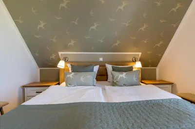 Ein Bett oder Betten in einem Zimmer der Unterkunft Haus TraumAnker