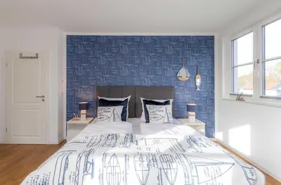 Ein Bett oder Betten in einem Zimmer der Unterkunft 5 Sterne Ferienhaus Ostseenest mit Boddenblick