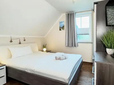 Ein Bett oder Betten in einem Zimmer der Unterkunft Wellenbrecher