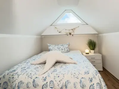 Ein Bett oder Betten in einem Zimmer der Unterkunft Wellenbrecher