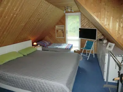 Ein Bett oder Betten in einem Zimmer der Unterkunft Ferienhaus Zingst MinHus