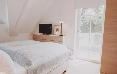 Ein Bett oder Betten in einem Zimmer der Unterkunft Ferienhäuser Doppelhaushälfte am Grenzweg