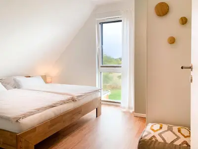 Ein Bett oder Betten in einem Zimmer der Unterkunft Ferienhaus Redensee