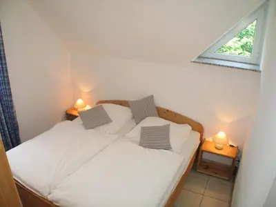 Ein Bett oder Betten in einem Zimmer der Unterkunft Ferienwohnung Sünnenkringel 58