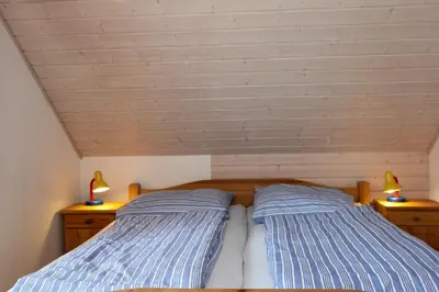 Ein Bett oder Betten in einem Zimmer der Unterkunft Bullerbü 1