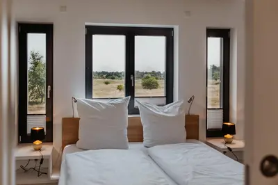Ein Bett oder Betten in einem Zimmer der Unterkunft SandKorn 1 und 2