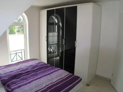 Ein Bett oder Betten in einem Zimmer der Unterkunft Magister Wigbold Ferienwohnung 13 Birkenstr10a