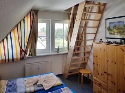 Ein Bett oder Betten in einem Zimmer der Unterkunft Das Gelbe vom Darss 7