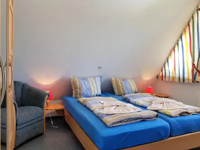 Ein Bett oder Betten in einem Zimmer der Unterkunft Das Gelbe vom Darss 7