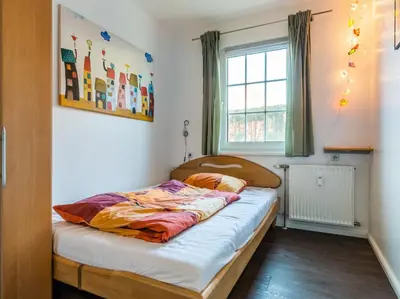 Ein Bett oder Betten in einem Zimmer der Unterkunft Dat gele Hus FeWo 1