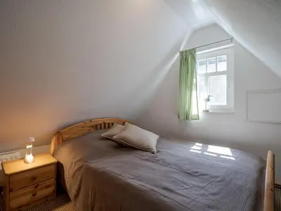 Ein Bett oder Betten in einem Zimmer der Unterkunft Hafenblick Ferienhaus