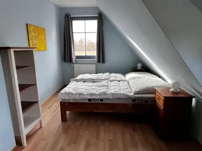 Ein Bett oder Betten in einem Zimmer der Unterkunft Ferien unterm Reet