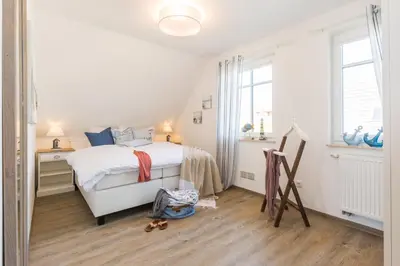Ein Bett oder Betten in einem Zimmer der Unterkunft Ostwestliebe