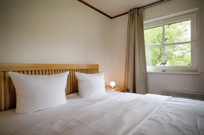 Ein Bett oder Betten in einem Zimmer der Unterkunft Sandsturm