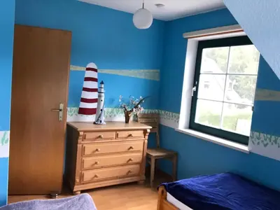 Ein Bett oder Betten in einem Zimmer der Unterkunft Ferienhaus Möwe - b49721