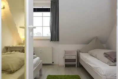 Ein Bett oder Betten in einem Zimmer der Unterkunft Kormoran Harry´s Place Q8