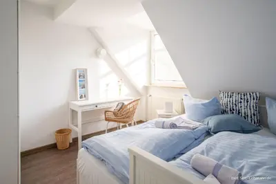 Ein Bett oder Betten in einem Zimmer der Unterkunft Kormoran Traumstrand