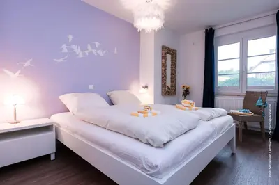 Ein Bett oder Betten in einem Zimmer der Unterkunft Kormoran Kranichflug
