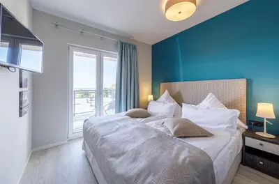 Ein Bett oder Betten in einem Zimmer der Unterkunft Dünenquartier - 3 Obergeschoss mit Ostseeblick - 600m zum Strand