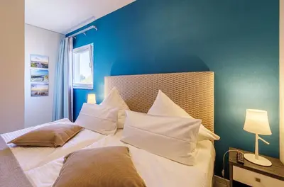 Ein Bett oder Betten in einem Zimmer der Unterkunft Dünenquartier - 3 Obergeschoss mit Ostseeblick - 600m zum Strand