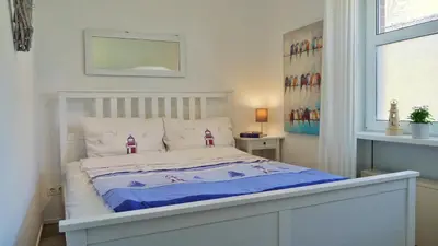 Ein Bett oder Betten in einem Zimmer der Unterkunft Kapitänsgarten Wohnung 25