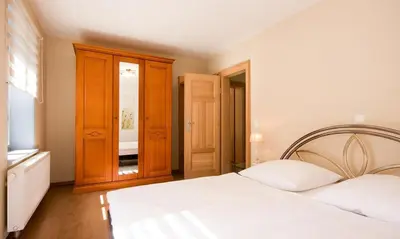 Ein Bett oder Betten in einem Zimmer der Unterkunft Haus zu den Büschen 03