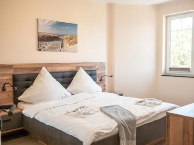 Ein Bett oder Betten in einem Zimmer der Unterkunft Strandstraße 16 - Wohnung 2