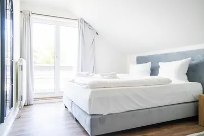 Ein Bett oder Betten in einem Zimmer der Unterkunft Johouse Zingst Johouse Zimmer 16