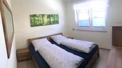 Ein Bett oder Betten in einem Zimmer der Unterkunft Kompassrose