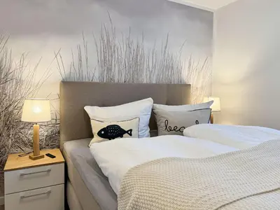 Ein Bett oder Betten in einem Zimmer der Unterkunft Küstenkajüte Whg 1