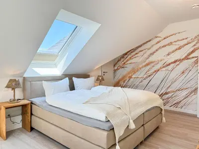 Ein Bett oder Betten in einem Zimmer der Unterkunft Küstenkajüte Whg 7