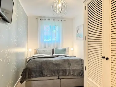 Ein Bett oder Betten in einem Zimmer der Unterkunft Küstenkajüte Whg 2