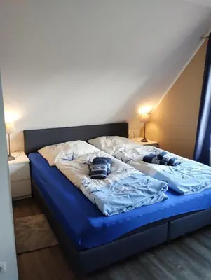 Ein Bett oder Betten in einem Zimmer der Unterkunft HuusamDarß