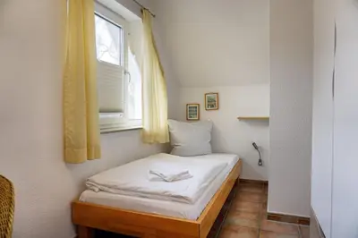 Ein Bett oder Betten in einem Zimmer der Unterkunft StrandglückHaus Sophie