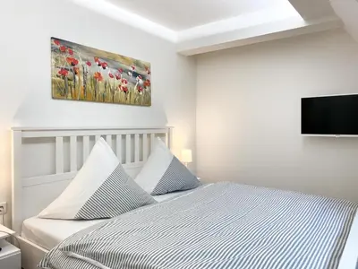 Ein Bett oder Betten in einem Zimmer der Unterkunft Sonnenseite Parkliebe, App 04