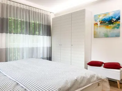 Ein Bett oder Betten in einem Zimmer der Unterkunft Sonnenseite Parkliebe, App 04