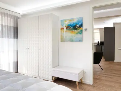 Ein Bett oder Betten in einem Zimmer der Unterkunft Sonnenseite Parkliebe, App 04