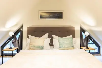 Ein Bett oder Betten in einem Zimmer der Unterkunft Goldregen - waldnah mit Kamin und Balkon