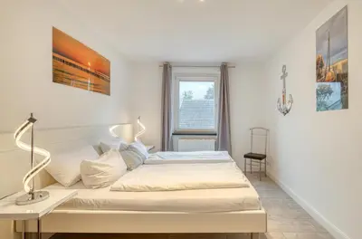 Ein Bett oder Betten in einem Zimmer der Unterkunft 5-Sterne-Apartment Ostseeblick inklusive Strandkorb von April-Oktober