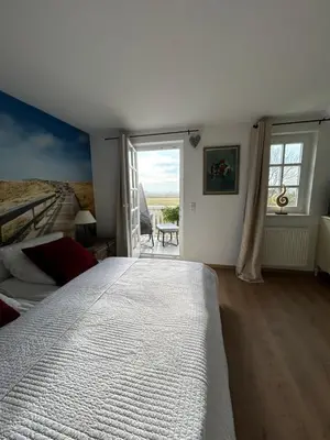 Ein Bett oder Betten in einem Zimmer der Unterkunft Ferienhaus Sturmmöwe Müggenburg