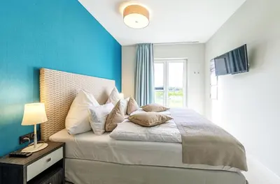 Ein Bett oder Betten in einem Zimmer der Unterkunft 5 Sterne Apartment Dünenkieker mit einer traumhaften Atmosphäre
