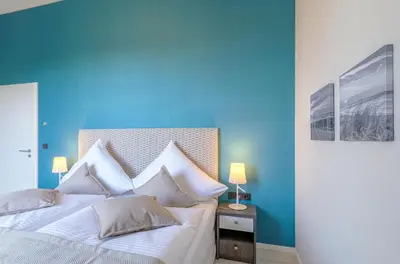 Ein Bett oder Betten in einem Zimmer der Unterkunft Käptenslounge - Ferienapartment für vier Personen mit Westbalkon und komfortabler Ausstattung