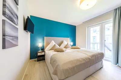 Ein Bett oder Betten in einem Zimmer der Unterkunft Große Strandmuschel - 5-Sterne Ferienwohnung zwischen Ostsee und Bodden