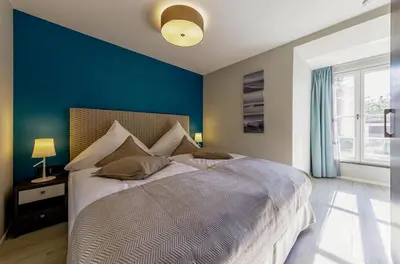 Ein Bett oder Betten in einem Zimmer der Unterkunft Lüttkoje - Ferienwohnung mit zwei Schlafzimmern
